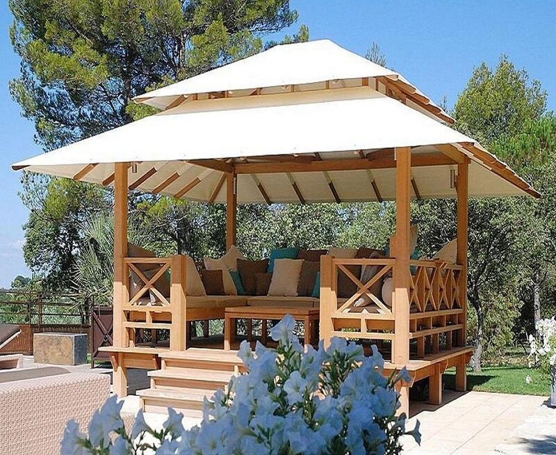 Wooden gazebo with white canopy