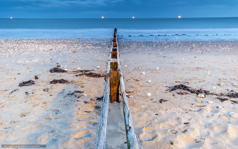 Wooden groynes on a pebble beach
