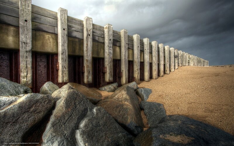Wooden groynes on a stormy beach