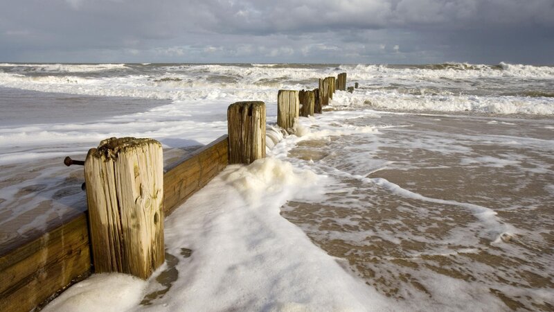Wooden groynes on a stormy beach