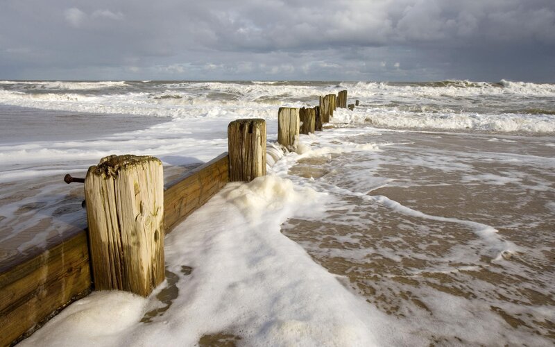 Wooden groynes on a stormy beach