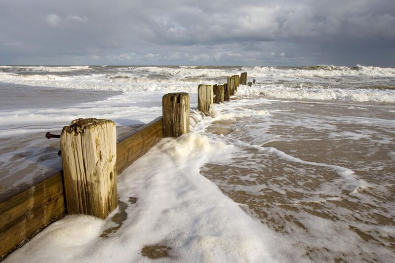 Wooden groynes on a stormy beach