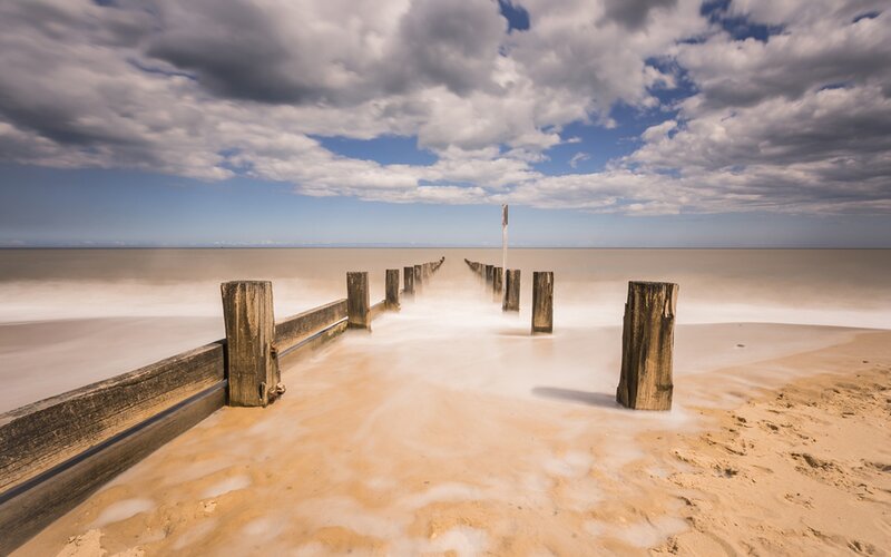 Wooden Groynes on Beach — Blue, Dramatic, Afternoon, Photograph