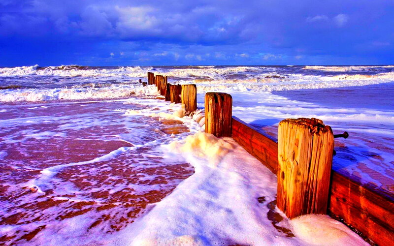 Wooden Groynes on Beach — Blue, Dramatic, Sunset