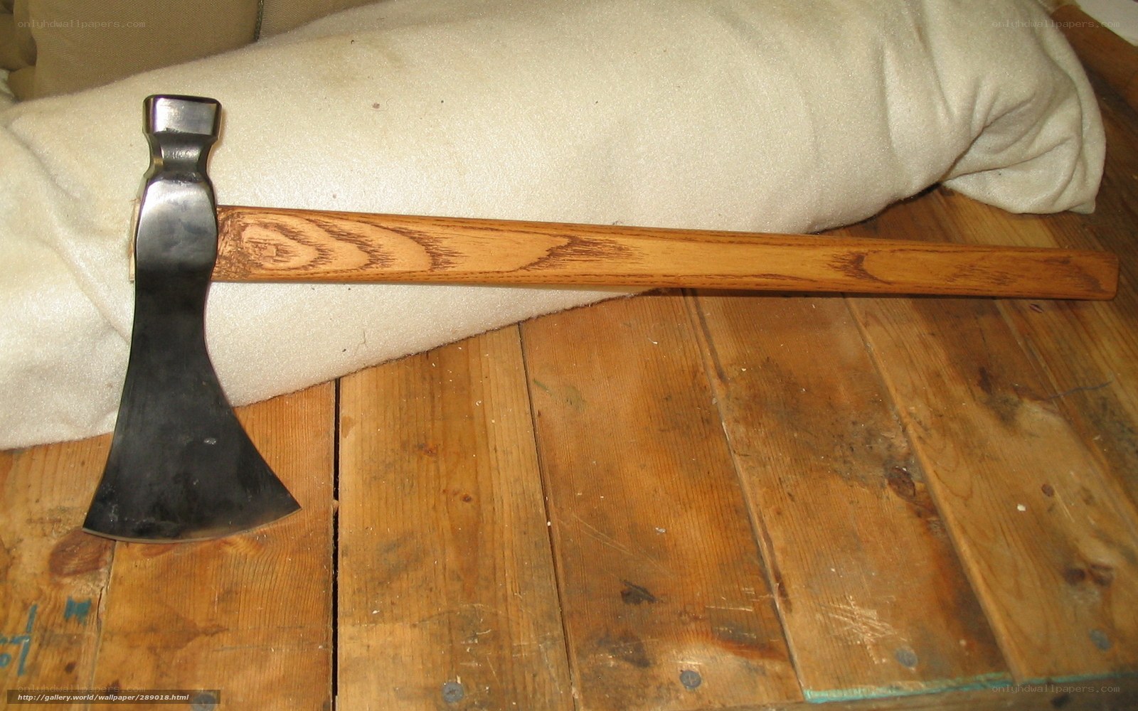 wooden-handled axe on floor