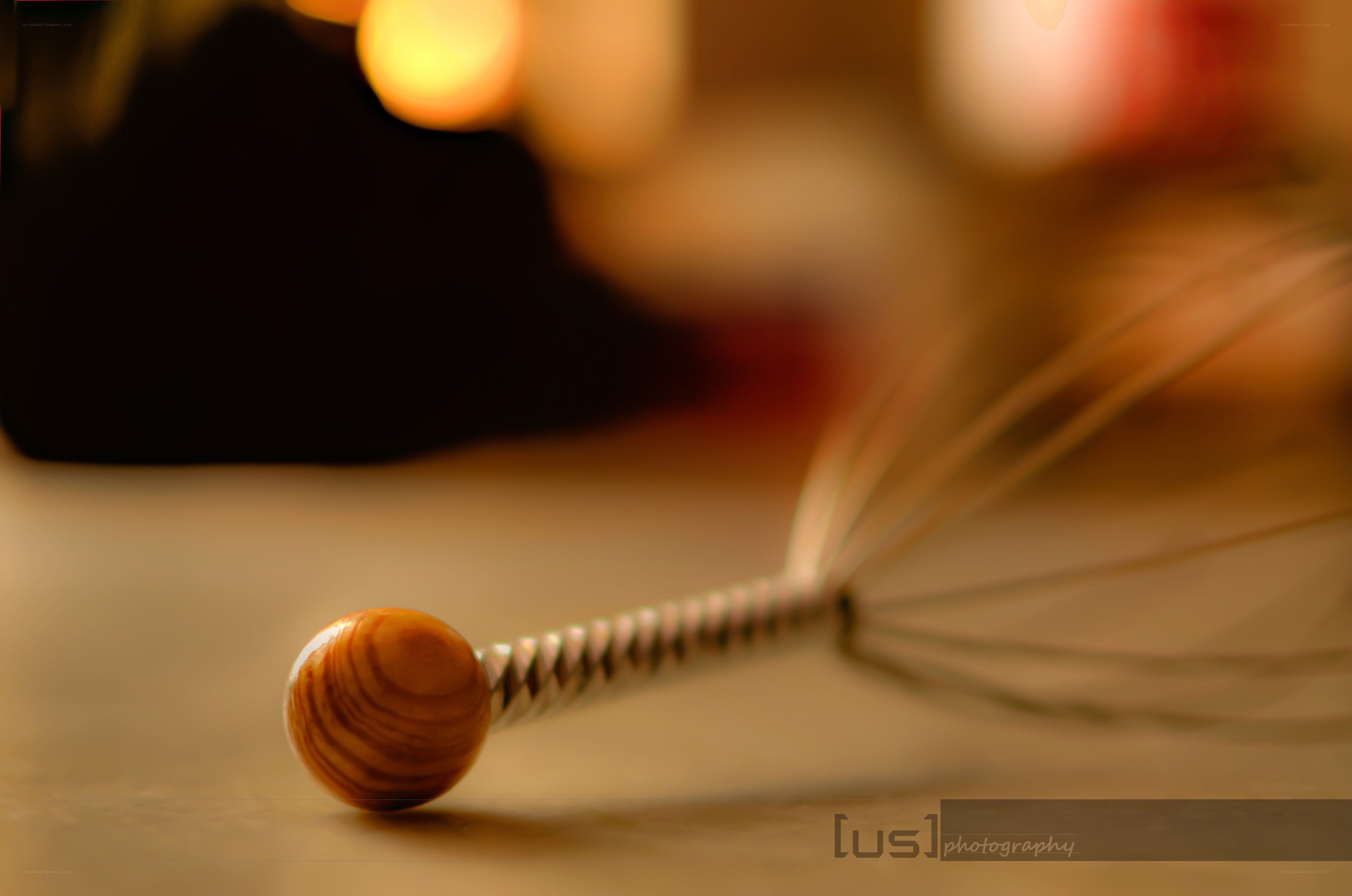 wooden-handled whisk on table