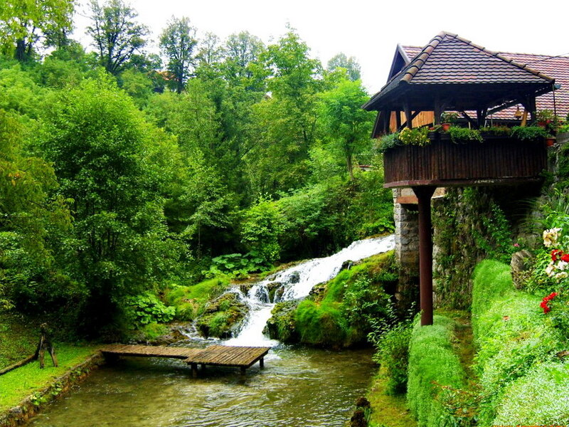 Wooden House by Waterfall