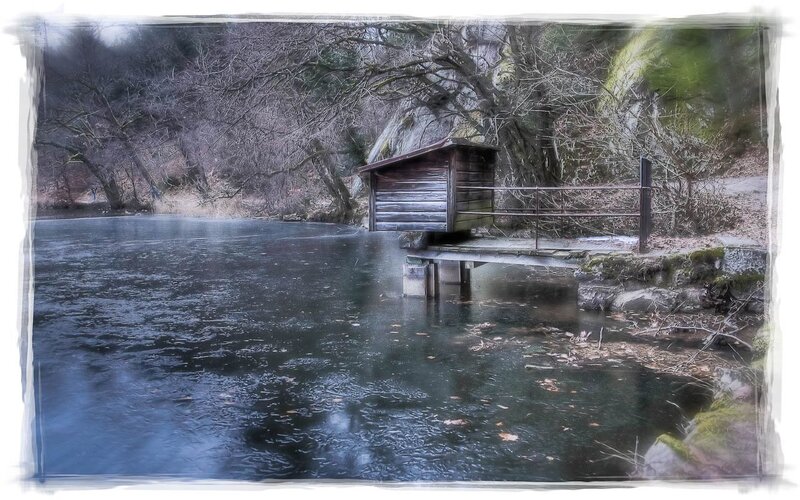 wooden hut on frozen lake