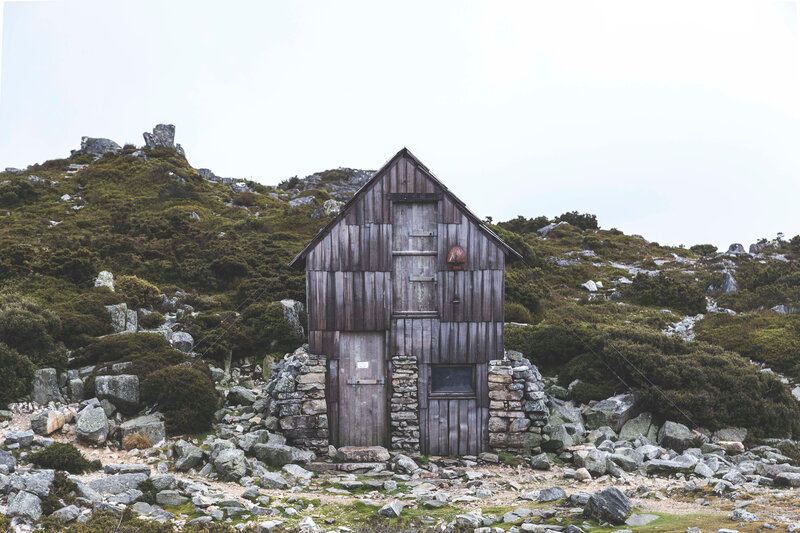 Wooden hut on rocky hillside