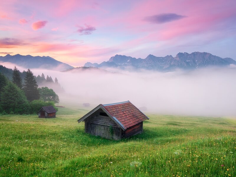 Wooden Huts in Meadow — Green, Serene