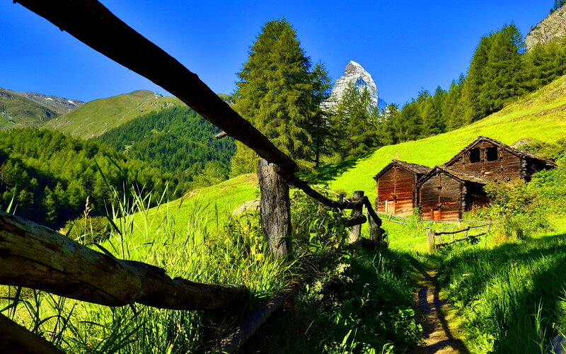 Wooden Huts in Mountains — Green, Serene