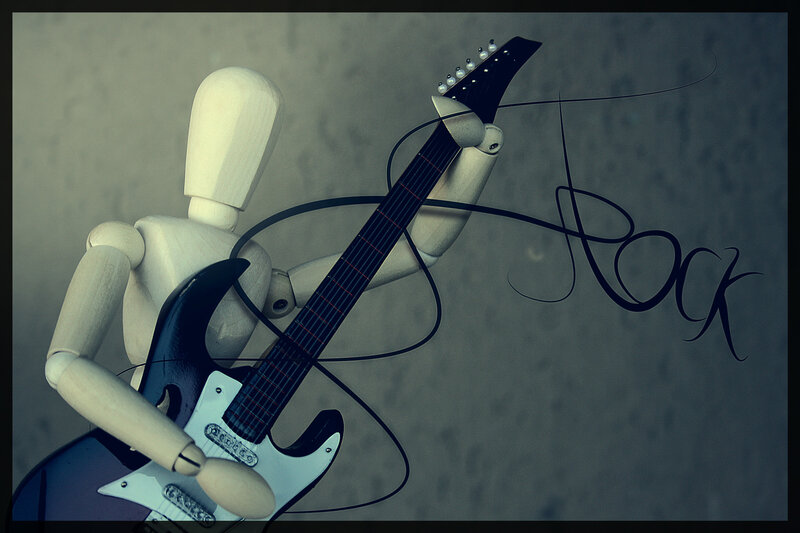Wooden mannequin playing guitar