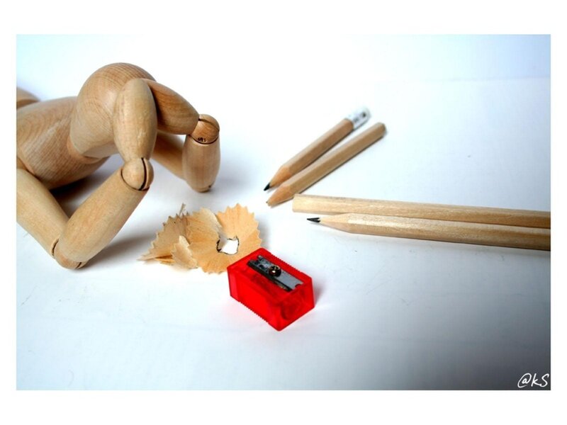 Wooden mannequin with pencils