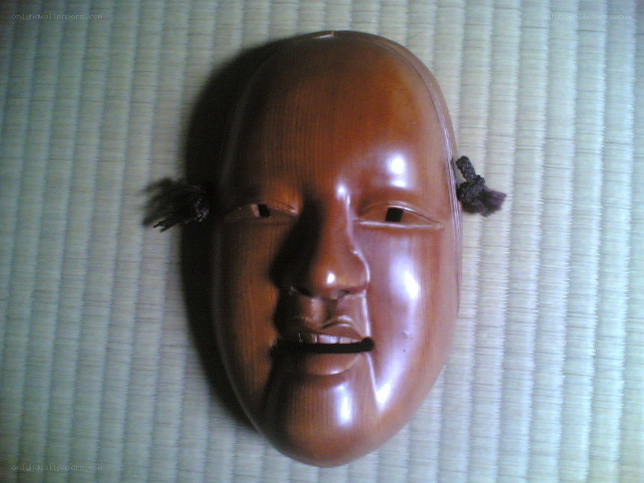 wooden mask on tatami mat
