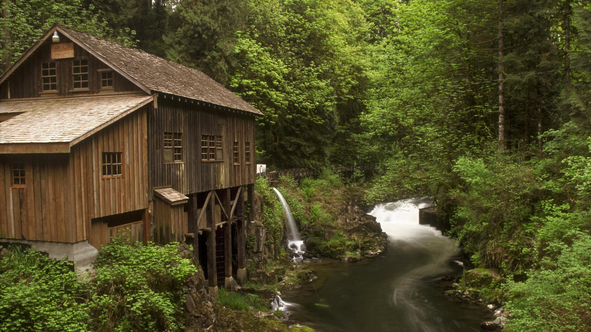 wooden mill by forest stream