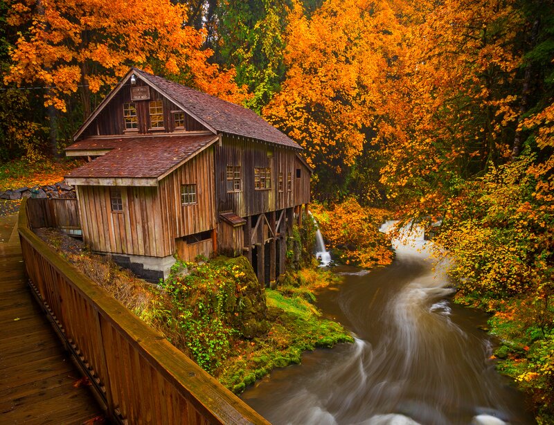 Wooden Mill by River — Orange, Serene, Autumn, Photograph, Trees, Bridge