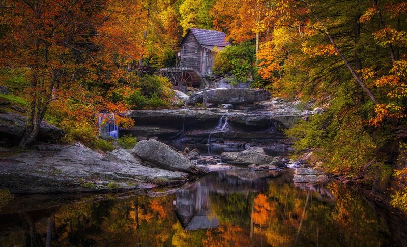 Wooden Mill by River — Orange, Serene, Autumn, Photograph, Trees, Fall Foliage