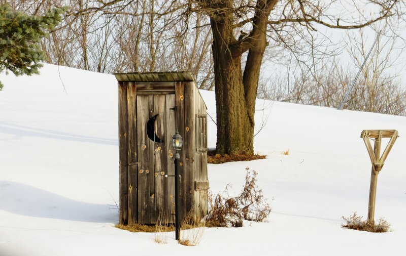 Wooden Outhouse in Snow