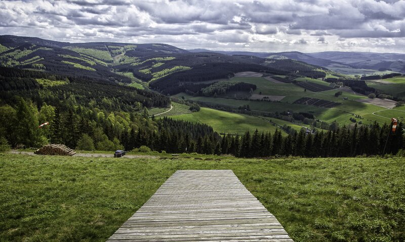 Wooden path in a green valley