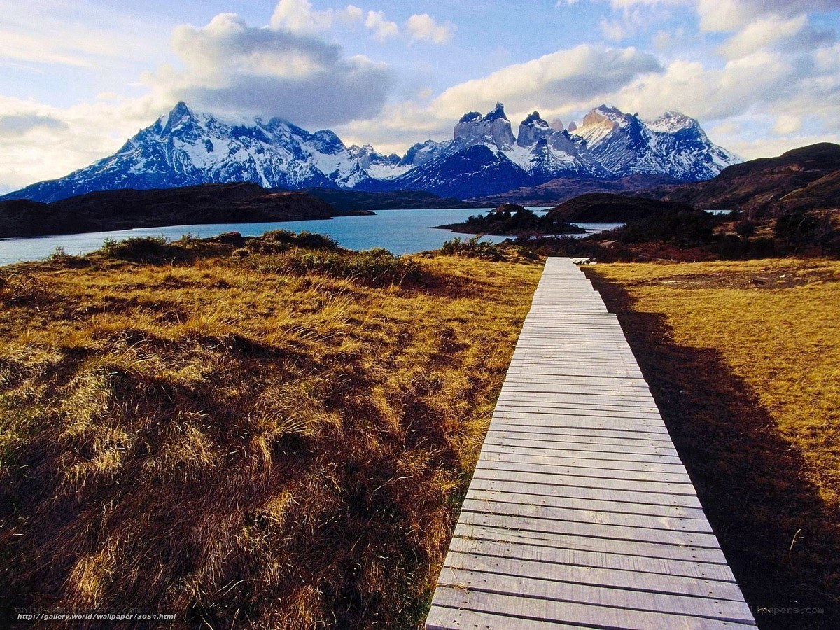 Wooden path to snow-capped mountains