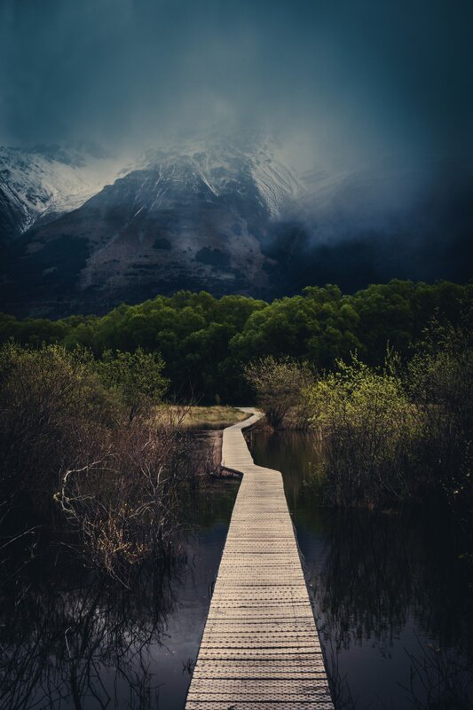 Wooden path to snowy mountain