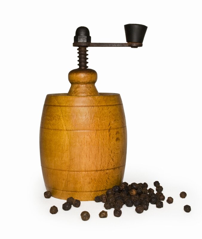 wooden pepper grinder with peppercorns