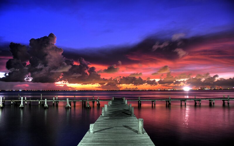 Wooden Pier at Sunset — Blue, Dramatic, Photograph, Clouds, City Lights, Water