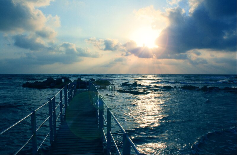 Wooden Pier at Sunset — Blue, Serene, Photograph, Ocean, Sun, Clouds, Rocks