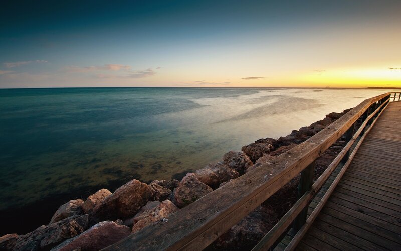 Wooden Pier at Sunset — Blue, Serene, Photograph, Rocks, Ocean
