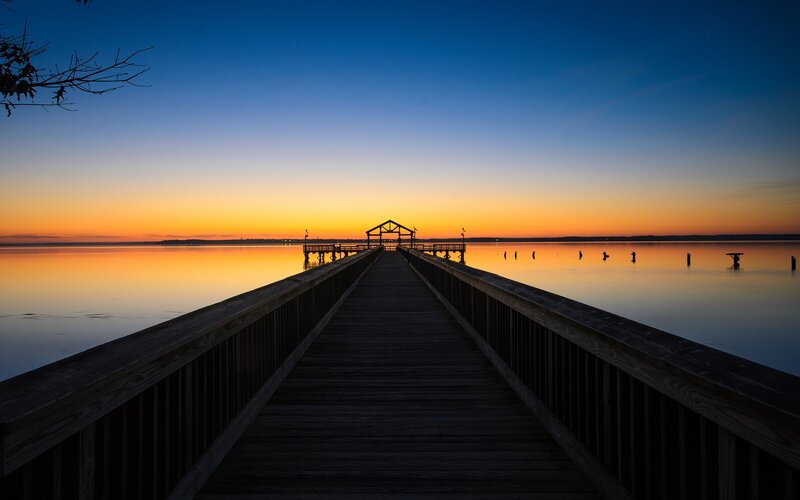 Wooden Pier at Sunset — Blue, Serene, Photograph, Sky, Water, Trees