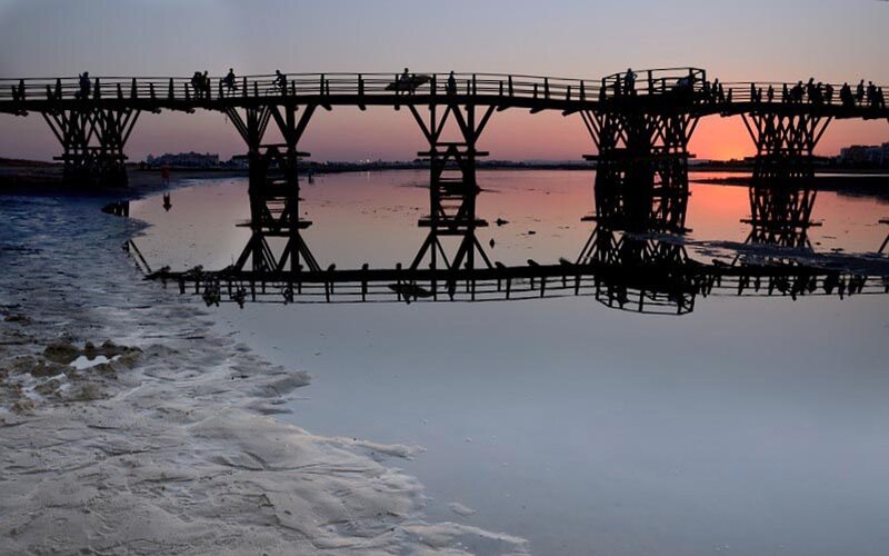 Wooden Pier at Sunset — Pink, Serene, Photograph, People