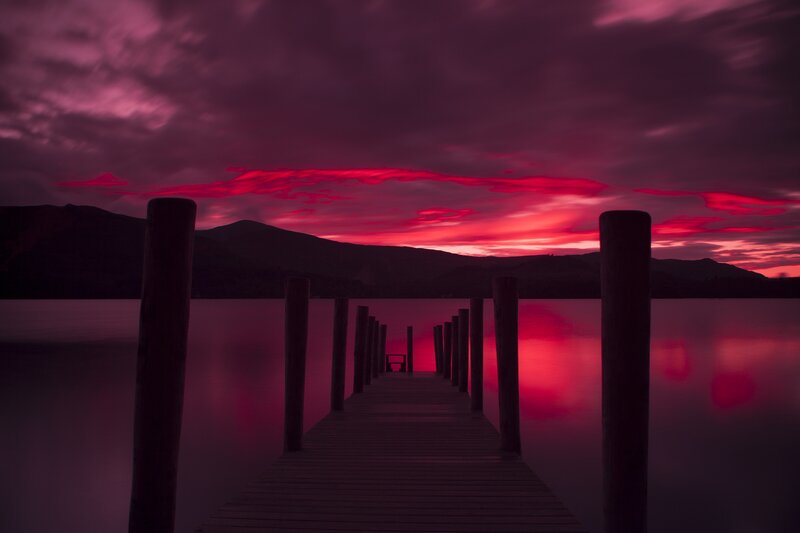 Wooden Pier at Sunset — Red, Dramatic, Photograph, Mountains, Sky