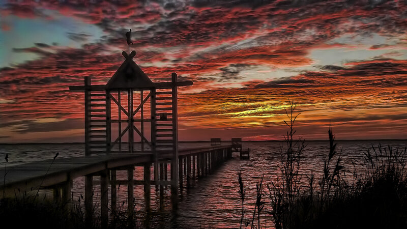 Wooden Pier at Sunset — Red, Dramatic, Photograph, Sky, Water, Plants