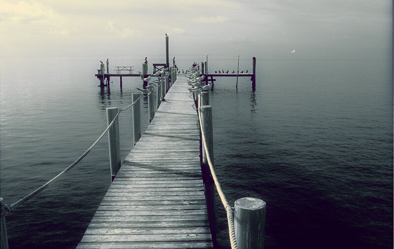 Wooden pier extending into calm water