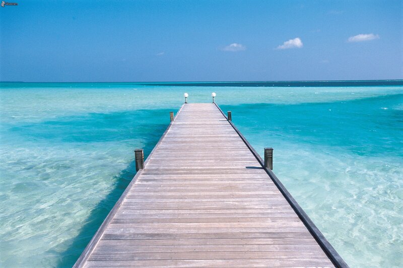 Wooden Pier Extending into Ocean — Blue, Serene, Afternoon, Photograph