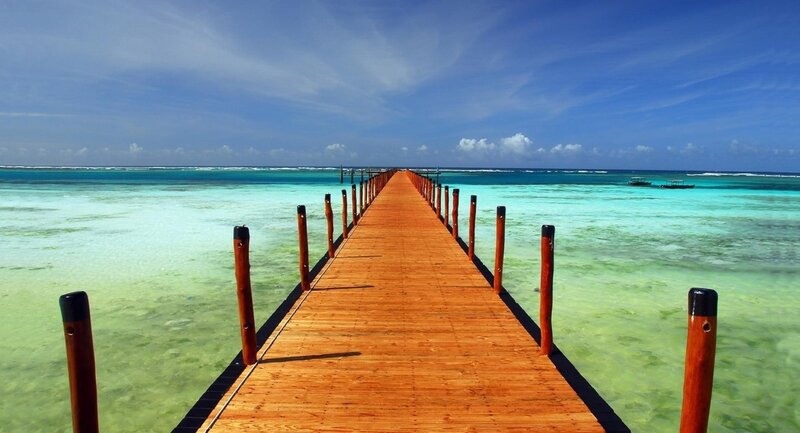 Wooden Pier Extending into Ocean — Blue