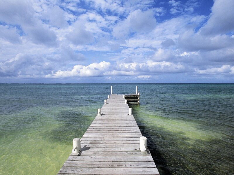 Wooden Pier Extending into Ocean — Serene