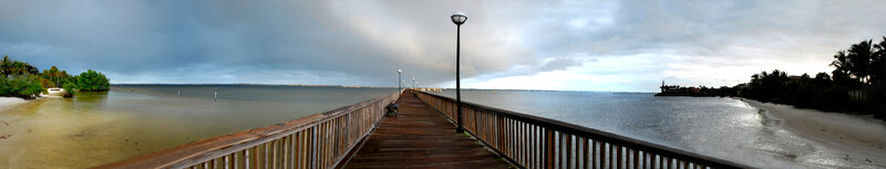 Wooden Pier Extending into Water — Brown