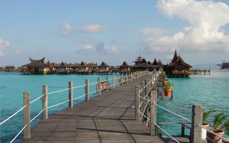 Wooden pier leading to overwater bungalows