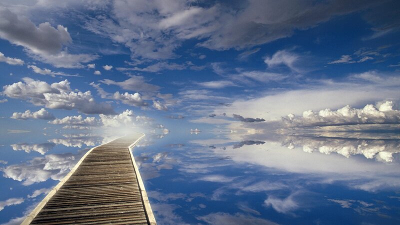 Wooden pier leading to sky