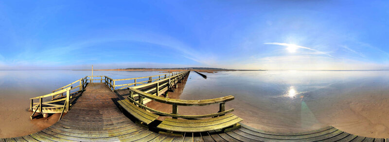 Wooden pier on calm beach