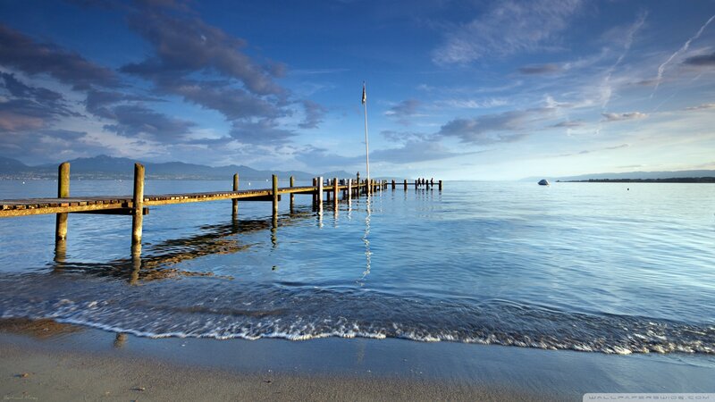 Wooden Pier on Lake — Blue, Serene, Sunset, Photograph, Mountains, Flagpole