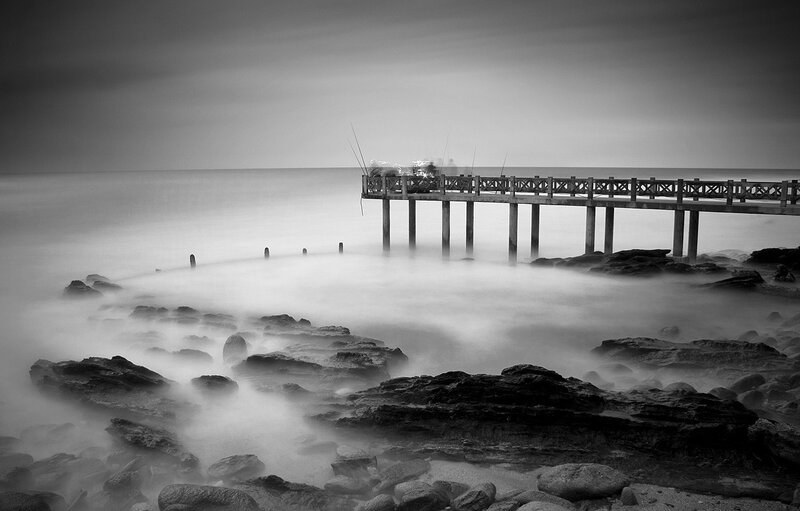 Wooden Pier on Rocky Shore
