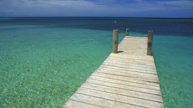Wooden pier over turquoise water