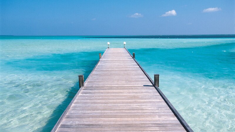 Wooden pier over turquoise water