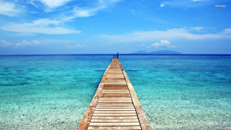 Wooden pier over turquoise water