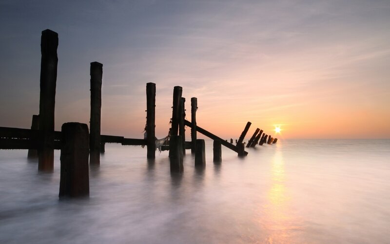 Wooden Pier Posts — Orange, Serene, Sunset