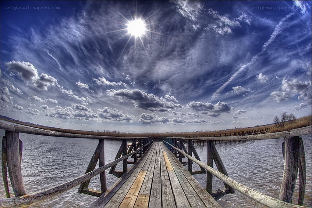Wooden pier under a bright sky