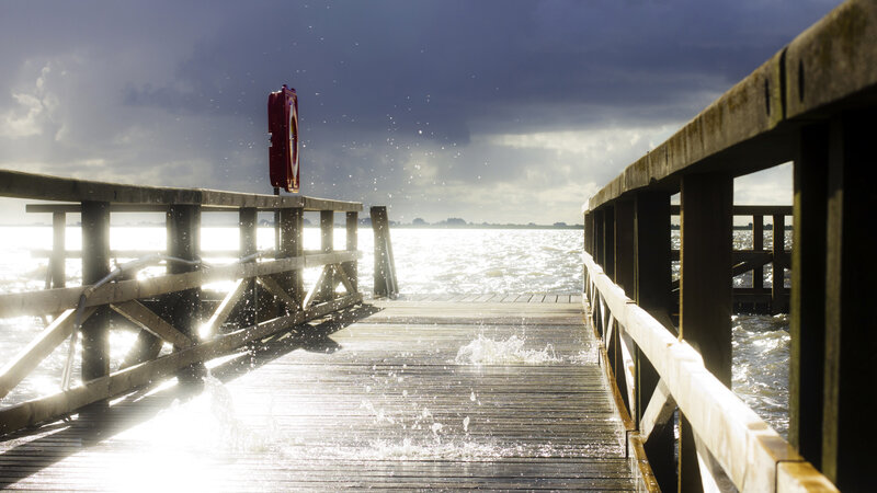 Wooden pier with splashing water