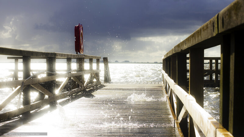 Wooden pier with splashing water
